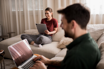 Young couple working together from home.