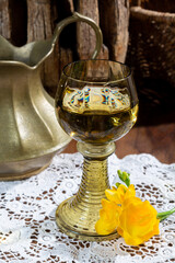 Antique German glassware, old Dutch style rummer or roemer glasses with white wine on white lace...