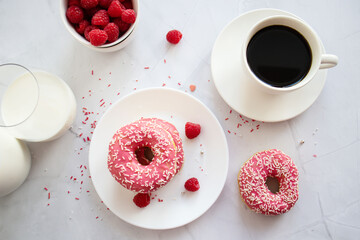 Fototapeta na wymiar Donuts with coffee and milk. Donut with pink frosting 