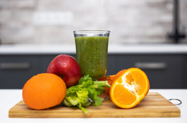 healthy smoothie in glass and fruits all around on wooden board kitchen table and background.slim...
