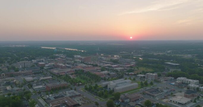 Aerial Panning Shot Of Town Hall Amidst Residential Buildings, Drone Descending Forward During Sunset - Tuscaloosa, Alabama