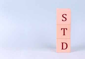 STD on wooden cubes on a blue background