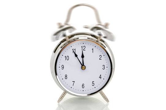 Ringing alarm clock, time set to five minutes to twelve, symbolic image