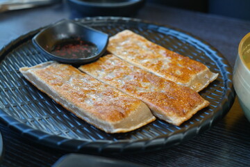 This crepe-like korean dish is made by pan-frying buckwheat batter and  rolling it with chopped radish, napa cabbage, and meat as a filling.