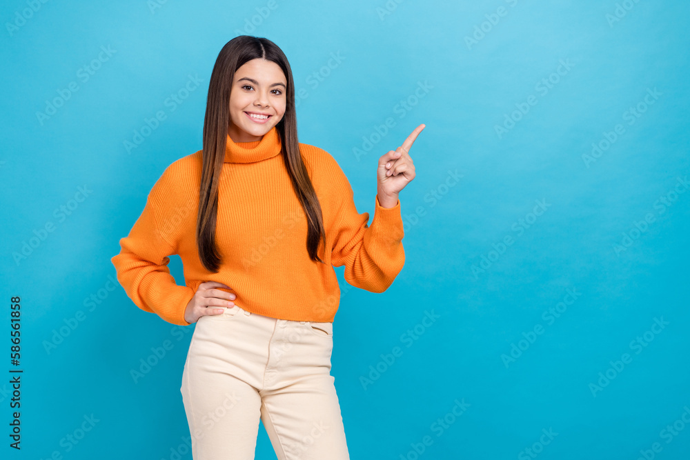 Sticker Photo of positive nice girl toothy smile indicate finger empty space proposition isolated on blue color background