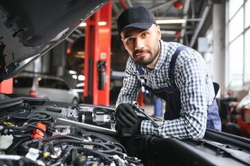 Fototapeta na wymiar Professional Mechanic is Working on a Car in a Car Service.