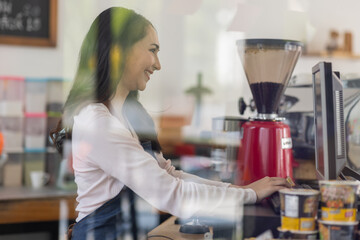 Startup successful small business owner sme beauty girl stand with tablet smartphone in coffee shop restaurant. Portrait of asian tan woman barista cafe owner. SME entrepreneur seller business concept