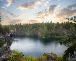 Fototapeta na wymiar Sunny landscape of forest and bright blue mountain lake