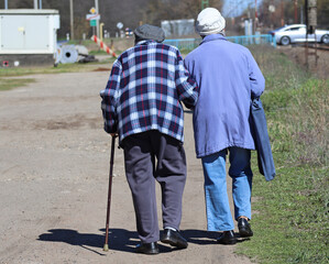 Senior couple walk on the dirt road