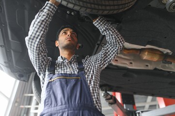 Fototapeta na wymiar Indian happy auto mechanic in blue suit.