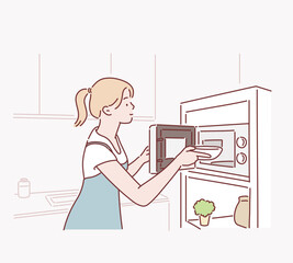 Woman cooking with a microwave in a modern kitchen. Hand drawn style vector design illustrations.