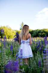 Fototapeta na wymiar Pretty girl in purple flowers field