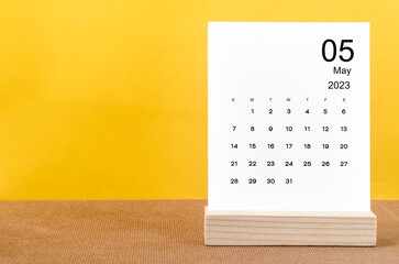 The May 2023 Monthly calendar for 2023 year on yellow table.