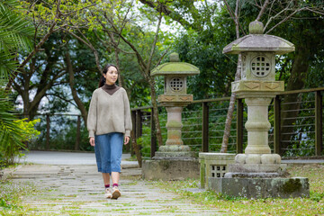 Woman walk in the Japanese green garden