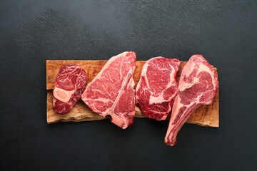Raw prime steaks. Variety of fresh black angus prime meat steaks T-bone, New York, Ribeye,...