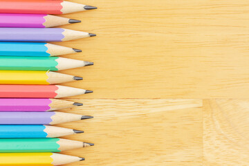 Pastel color pencils background on wood desk