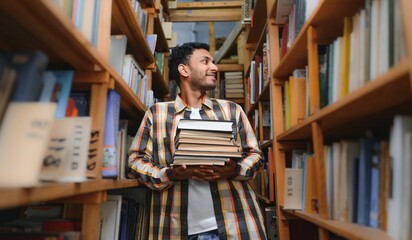 Clever arabian or indian male student or freelancer, in stylish casual clothes in the library © Serhii
