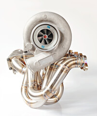 Turbocharger and exhaust manifold on white background