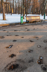 Pits in the asphalt from explosions of mines or bombs on the sidewalk in the park Kharkiv city,...