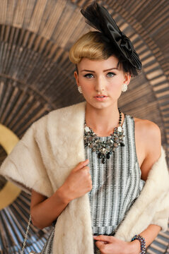 young woman with fur shawl and fancy dress hat