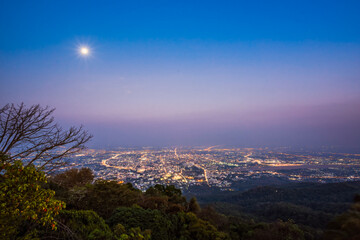 Fototapeta premium Aerial view, landscape of city at night from the top of mountain