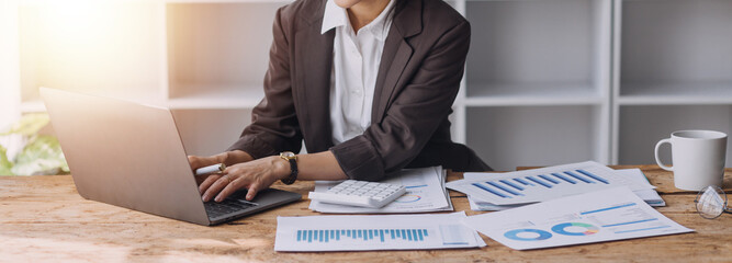 Close up bookkeepers working with balance sheet to analyze problems and find solutions to bringing...