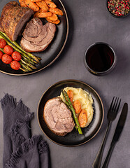 Food photography of roasted lamb, carrot, asparagus, tomato, seasoning, pepper