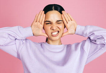 Fun and funny faces: Woman makes a funny expression in a studio