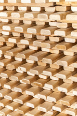 Large stack of new wooden lattices made of natural solid birch in contemporary carpentry warehouse close view as background