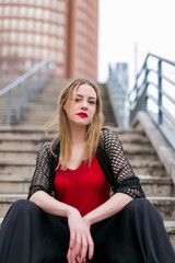 Young and Elegant Blonde Woman Sitting Outdoors