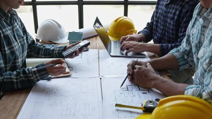 Construction concept of Engineer or architect meeting for project working with partner and engineering tools on model building and blueprint in working site.