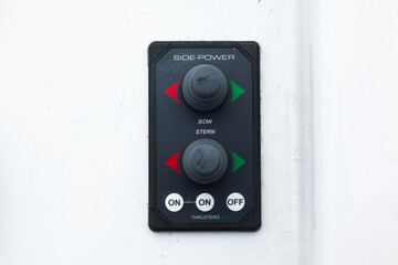 The control console of the bow and stern thrusters of a motor yacht with buttons and joysticks,...