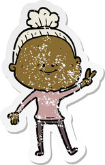 distressed sticker of a cartoon happy old woman