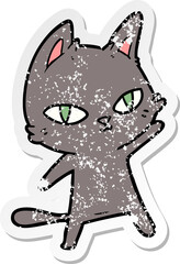 distressed sticker of a cartoon cat staring