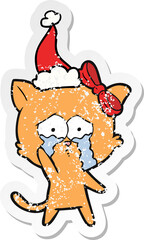 distressed sticker cartoon of a cat wearing santa hat