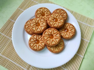 Biscuits with pineapple jam on a white plate