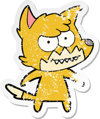 distressed sticker of a cartoon grinning fox