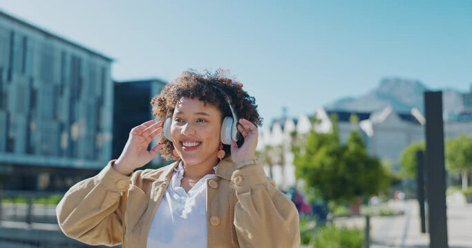 Headphones, dancing and woman in city for 5g music streaming, student wellness and campus lifestyle. Urban, gen z person dance and listening to audio tech moving with freedom and happiness