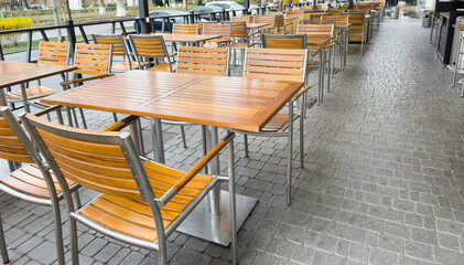 Empty stylish street cafe in a European city. Street restaurant. with terrace. Empty Cafe tables and chairs. Exterior of the cafe restaurant