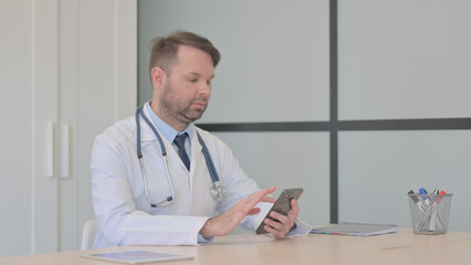 Young Doctor Using Smartphone at Work 