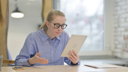 Young Woman Upset by Loss on Tablet at Work