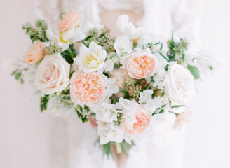 A Woman Holding A Lush Bouquet of wedding Flowers