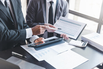 Finance and investment concept, Businessman present business finance investment plan with his partner, Investor colleagues discussing new investment plan by financial graph data on office table