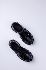 Top view of woman's lacquered loafer shoes on the white background.