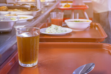 a tray of food on the table before eating in a food service close-up, the front and back backgrounds are blurred with a bokeh effect