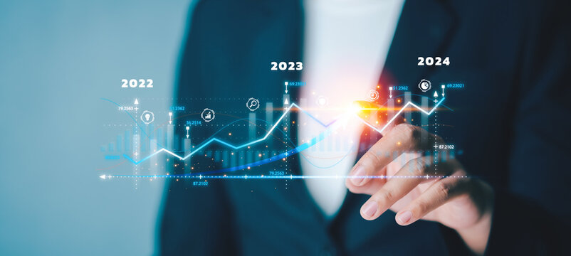 Business person analysing growing virtual hologram target of statistics graph and up arrow for trader to investment, the best business growth and strategy development and planning to success.