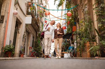 Fototapeta na wymiar Full Length Shot Of Happy Senior Tourists Couple Walking Outdoors