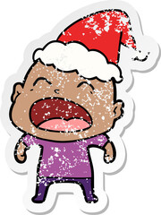 distressed sticker cartoon of a shouting bald man wearing santa hat