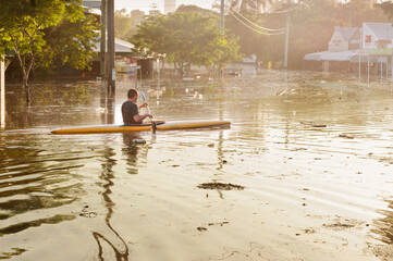 Man canoeing in flood waters