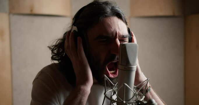 Alternative rock music singer singing song into microphone, shouting emotionally